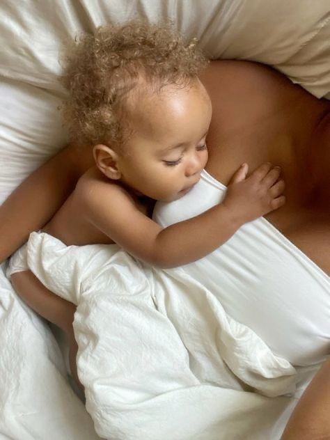 Baby resting peacefully beside a parent