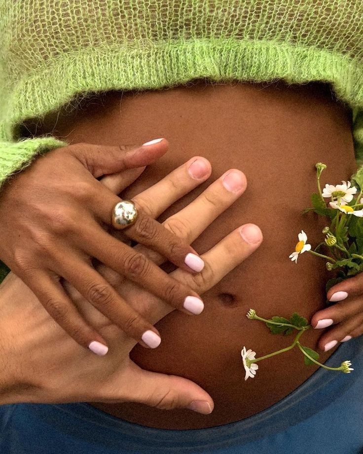 Expectant mother with flowers resting on her belly